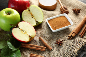 Composition with fresh apples and cinnamon on sack cloth