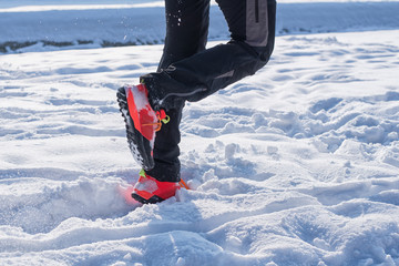 Handsome young runner on the snow.Colored photo