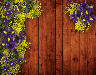Beautiful bright yellow and purple flowers on wood surface. Background with plenty room for your text and copy space.