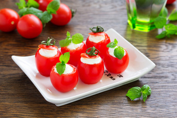 Cherry tomatoes stuffed with yogurt with mint.