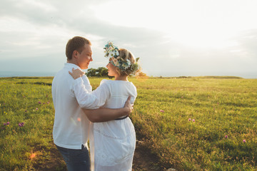 beautiful pregnant girl and her husband in the nature