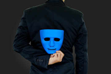 Businessman hide the mask.