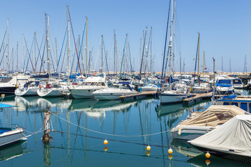 Fototapeta na wymiar Boats and yachts moored off in marina of Larnaka, Cyprus