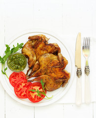 Roasted partridges of tobacco with salsa and tomato sauce.