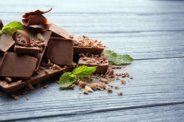 Dark chocolate pieces on wooden table
