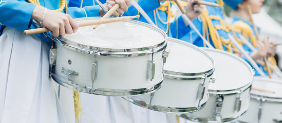 Fototapeta na wymiar Drummers in blue uniform stand in row and drumming