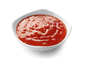 Tasty chili sauce in bowl on white background