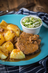 Braised meat in sauce served with boiled potatoes.