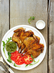 Roasted partridges of tobacco with salsa and tomato sauce.