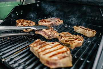 Grilled beef steak on the grill, close-up.