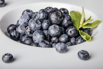 Blueberries in a bowl on a wooden table.