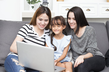 Happy family woman and kid using laptop at home, happy family concept, 3 person