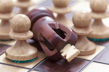 Business concept of win or defeat, loss Chessboard and figures of the king and pawns.
