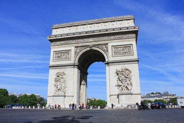Fototapeta na wymiar Arc de Triomphe on Champs Elysees street and Place Charles de Gaulle square in city of Paris. Famous tourist attraction landmark in Europe. Beautiful summer day scene with clear blue sky background.