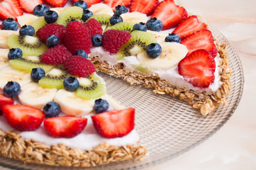 Healthy tart with red, blue, green and white fruit