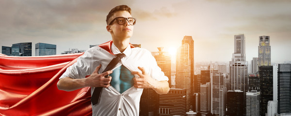 Business superhero. Young businessman or doctor showing super hero suit under his shirt down town...
