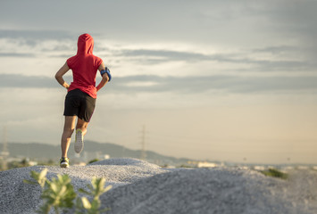 Woman running. Female runner jogging, training for marathon. Fit girl fitness athlete model exercising outdoor.