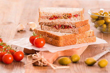 Tuna, olives and tomato sandwiches.