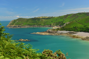 Naklejka premium Bonne Nuit Bay, Jersey, U.K. Picturesque secluded coastline in the Summer.