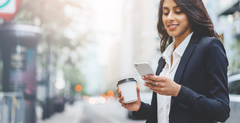 Professional business woman using technology outside, Professional female manager reading...