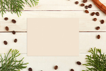 Coffee beans and spruce branches on wooden background. Space for text or design. Tflat lay and copy space.