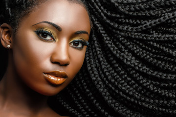 African cosmetic portrait of woman showing braided hairstyle. - obrazy, fototapety, plakaty