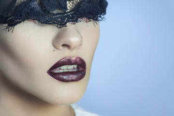 charming young lady with black lace on eyes and beautiful lips