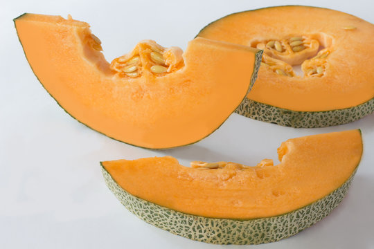 Pumpkin is cut into slices. Closeup. White background
