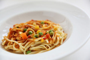 Fettuccine pasta in tomato sauce isolated in white background