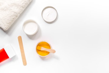 Concept depilation with wax and sticks on white background top view copyspace