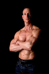 fit muscular man posing isolated on a dark background