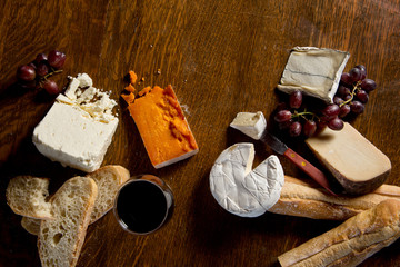 Overhead view of red wine served with charcuterie cheese