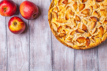 Apple pie, red apples on a gray background, horizontally, copyspace