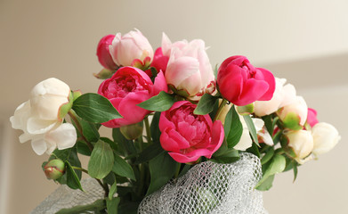 Bouquet of beautiful colorful peony flowers on blurred background, closeup