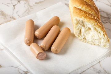 Sausages (Frankfurter) on table with bread