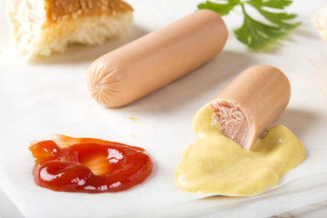 Eating Sausages (Frankfurter) with bread, mustard and ketchup