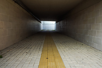 Sidewalk guides for blind. Yellow concrete cobblestones on walkway for blindness people in the...