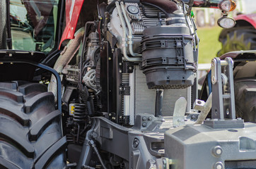 Powerful high-tech tractor engine in modern design, mounted on a frame with an open hood