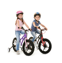Cute little children with bicycles on white background