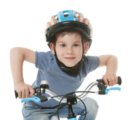 Cute little boy riding bicycle on white background