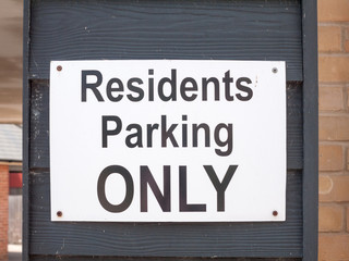 a private parking sign up close on wall outside