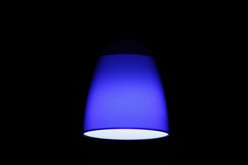 Blue luminaire against dark background