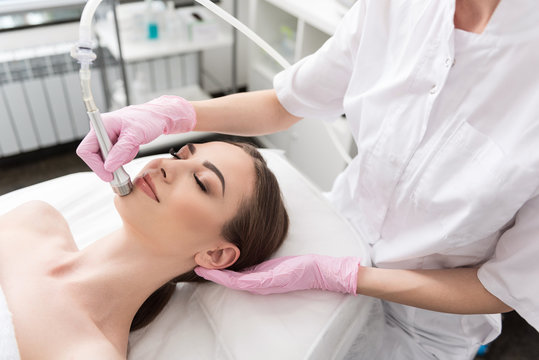 Pleasant delighted girl is lying on table in spa