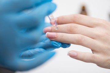 Nails master is laboring with client