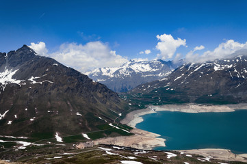 Obraz premium MontCenis Lake, France. Blue sky in a summer day. Trekking at 2400 mt and snow into the pathway