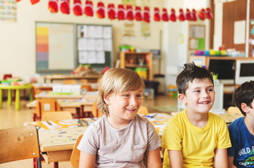 Two concentrated 4-5 year old boys in classroom