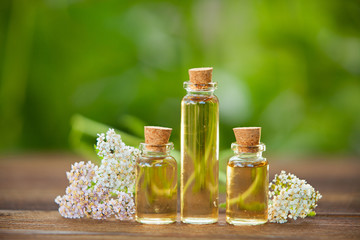 Essence of flowers on table in beautiful glass jar