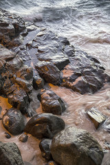 rocks on the beach on the sunset lights