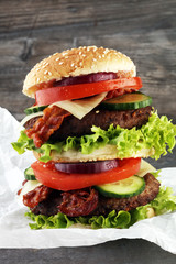 fresh tasty burger on wooden grey background