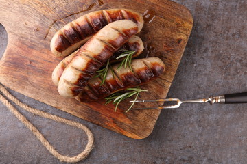 Grilled sausages with sauce ketchup on a wooden table - Home-made Pork Sausages